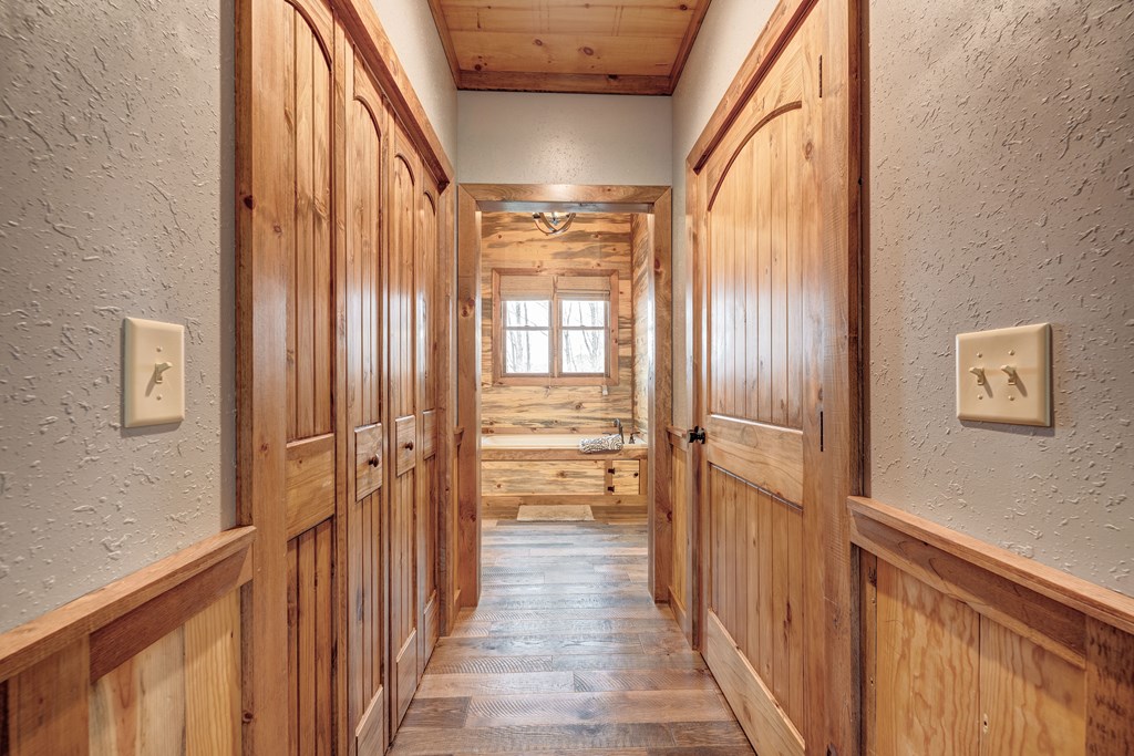 1601 Shady Falls Road Blue Ridge, GA 30513 - Photo 37 of 78 a view of a hallway with wooden floor and windows