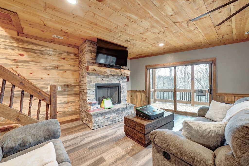 1601 Shady Falls Road Blue Ridge, GA 30513 - Photo 47 of 78 a living room with furniture and a fireplace