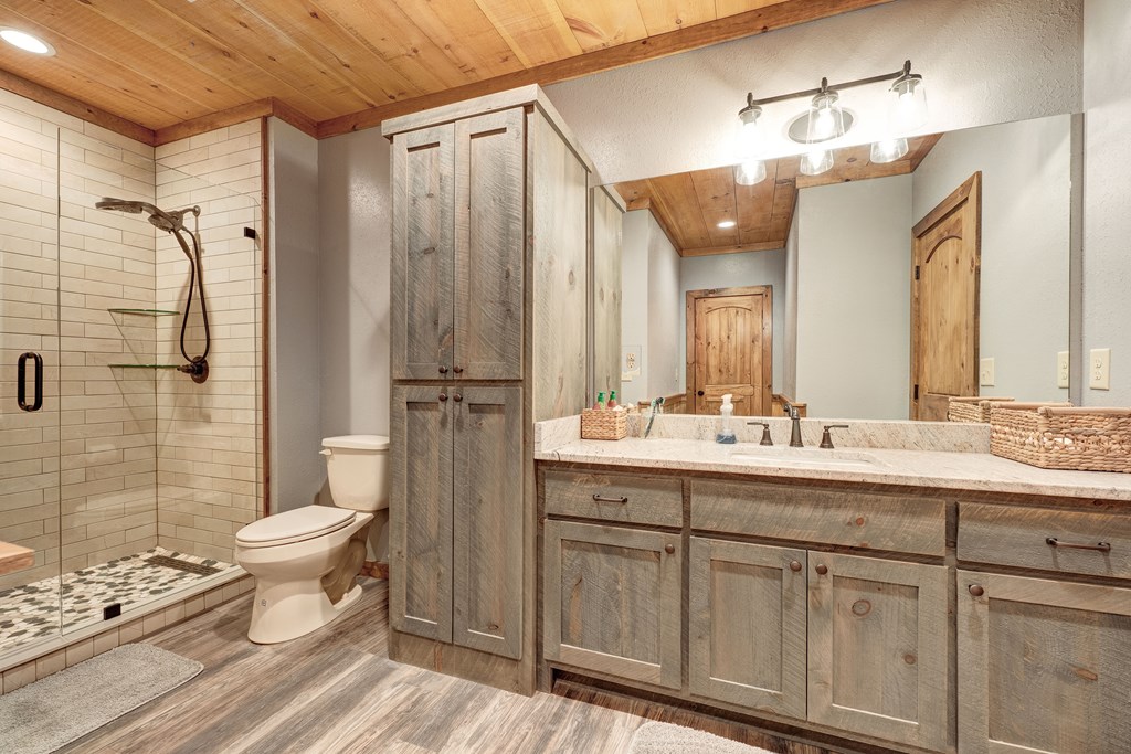 1601 Shady Falls Road Blue Ridge, GA 30513 - Photo 54 of 78 a bathroom with a double vanity sink toilet and shower