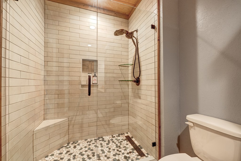 1601 Shady Falls Road Blue Ridge, GA 30513 - Photo 55 of 78 a bathroom with a toilet and shower