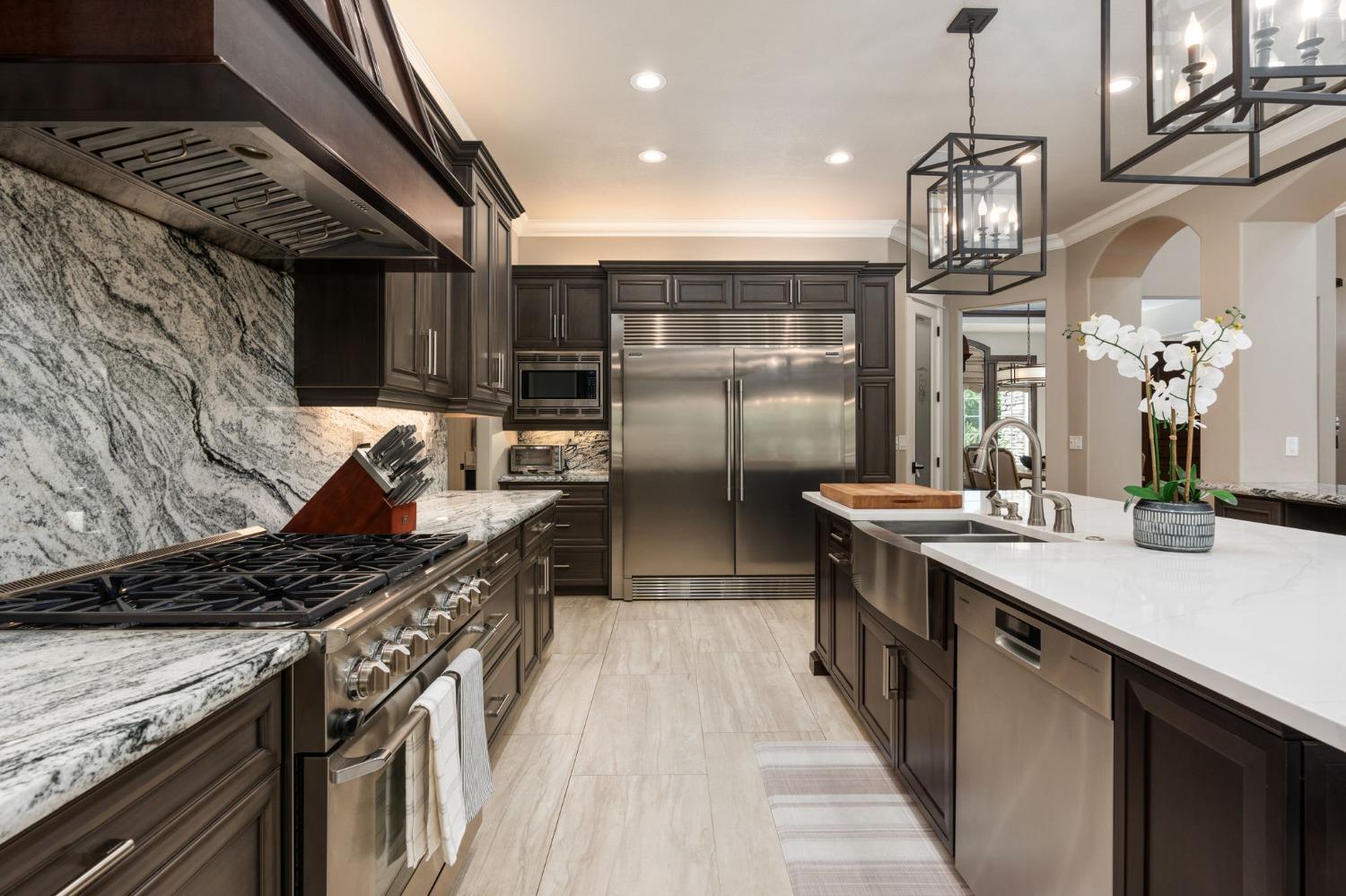 415 Heritage Avenue Clovis, CA 93619 - Photo 11 of 56 a kitchen with stainless steel appliances granite countertop a sink a stove and a refrigerator