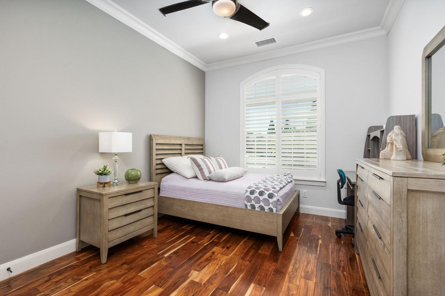 415 Heritage Avenue Clovis, CA 93619 - Photo 14 of 56 a bedroom with a bed and wooden floor