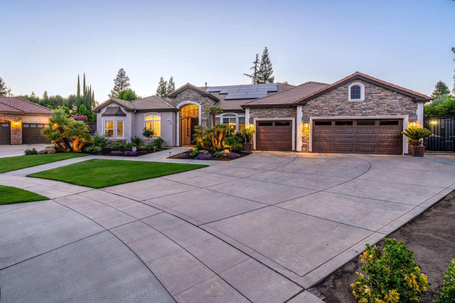 415 Heritage Avenue Clovis, CA 93619 - Photo 2 of 56 a front view of a house with a yard and garage