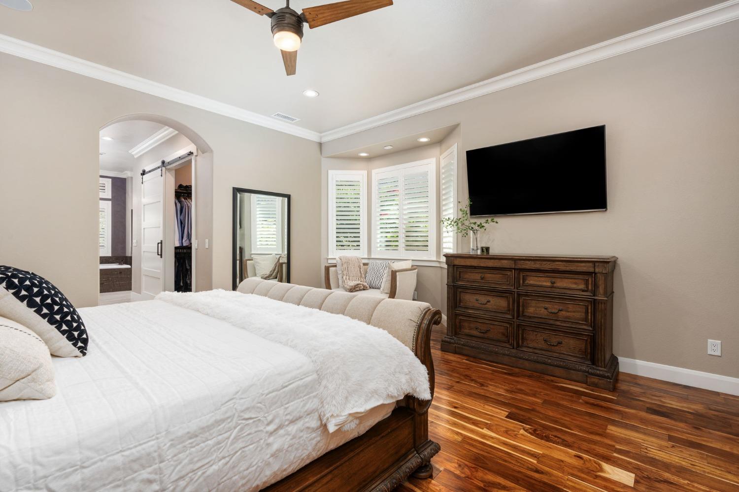 415 Heritage Avenue Clovis, CA 93619 - Photo 21 of 56 a bedroom with a bed and a flat screen tv