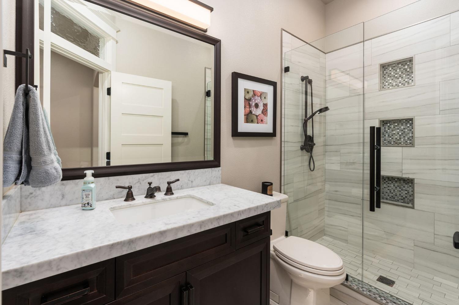 415 Heritage Avenue Clovis, CA 93619 - Photo 28 of 56 a bathroom with a sink toilet and shower