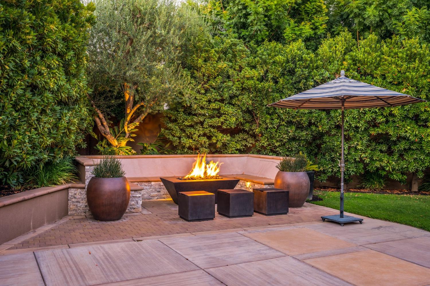 415 Heritage Avenue Clovis, CA 93619 - Photo 32 of 56 a view of a patio with table and chairs potted plants with wooden fence