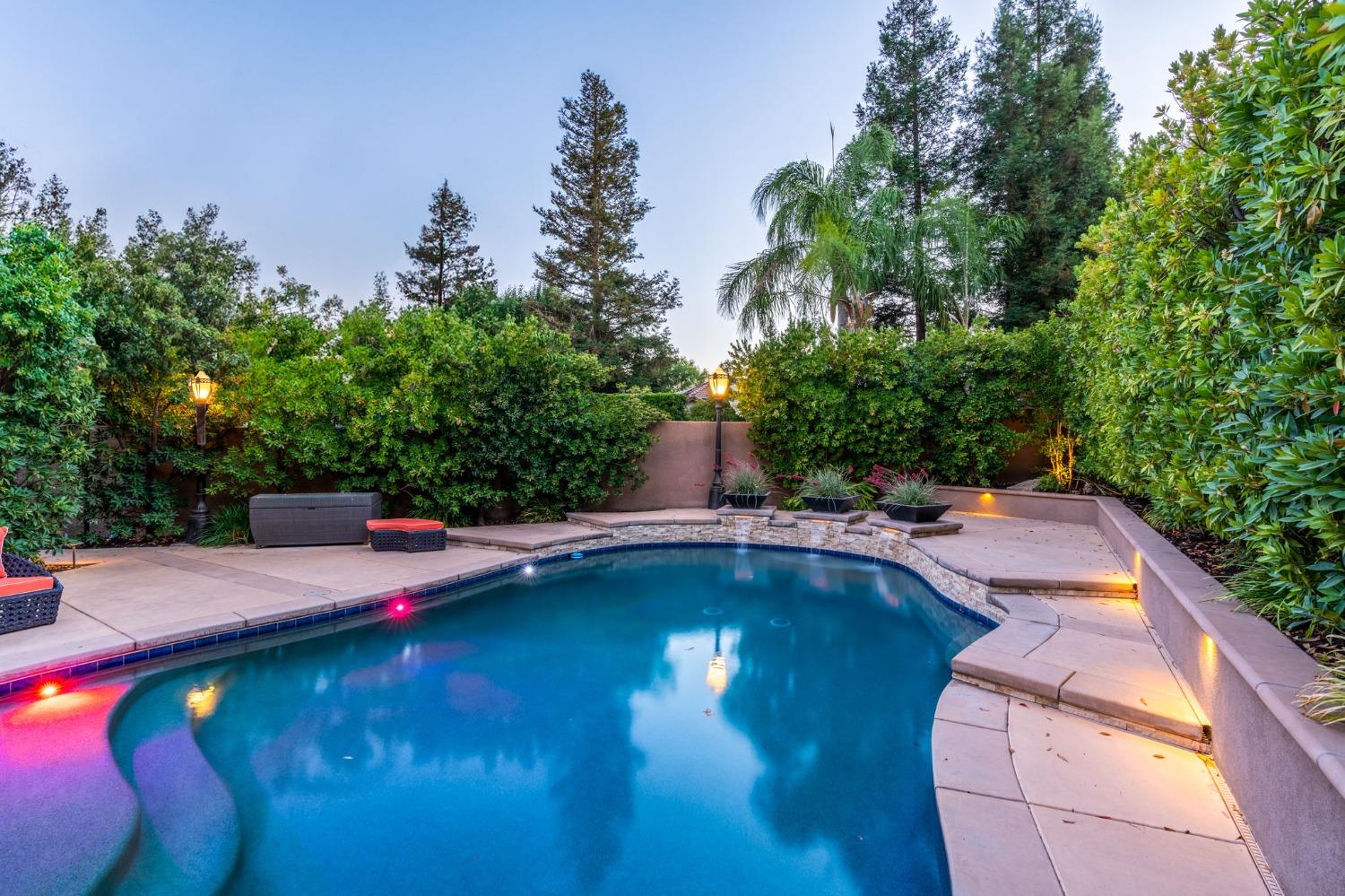 415 Heritage Avenue Clovis, CA 93619 - Photo 41 of 56 a view of swimming pool with seating space and trees in the background