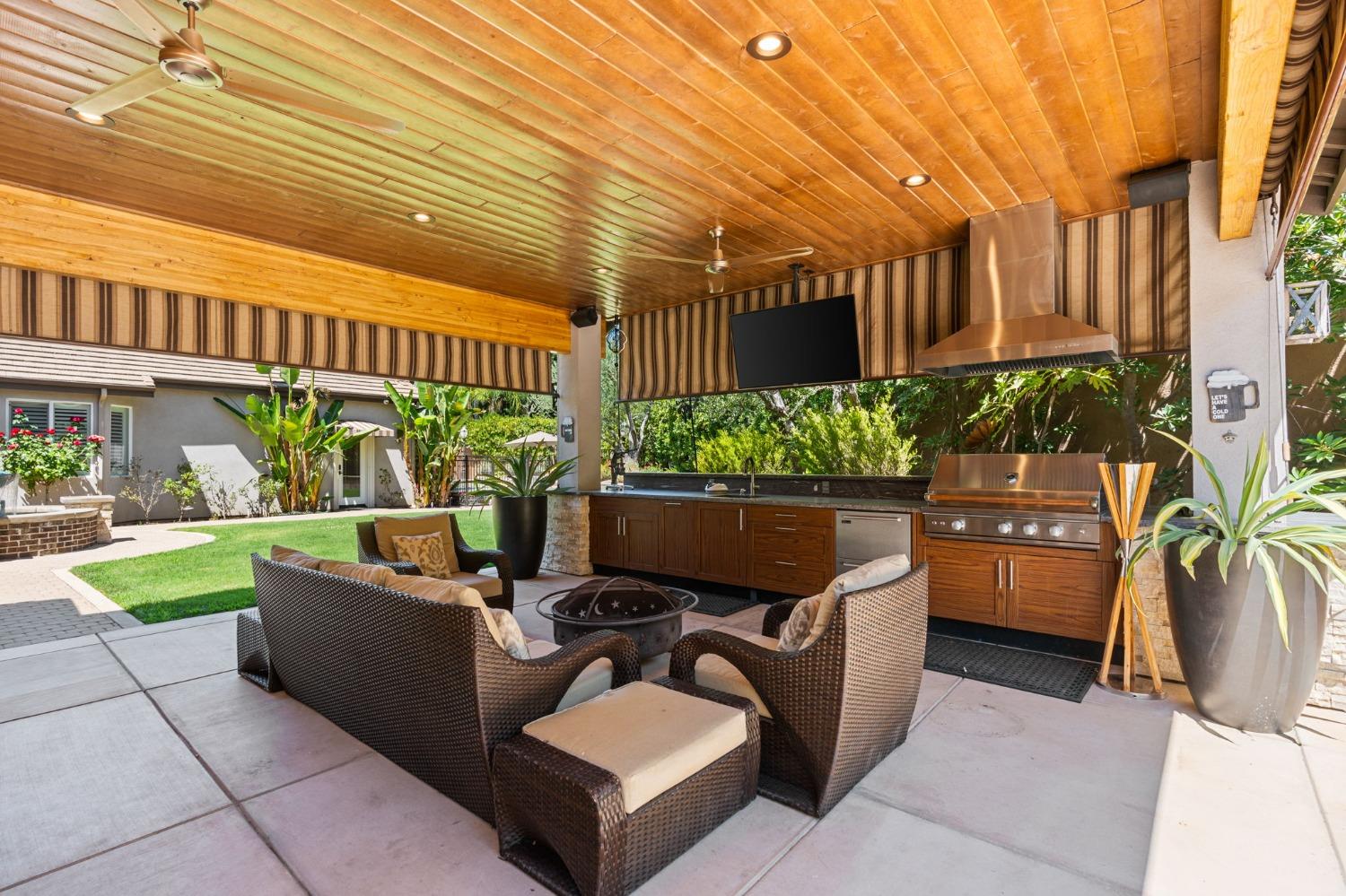 415 Heritage Avenue Clovis, CA 93619 - Photo 45 of 56 a view of a patio with couches table and chairs and potted plants