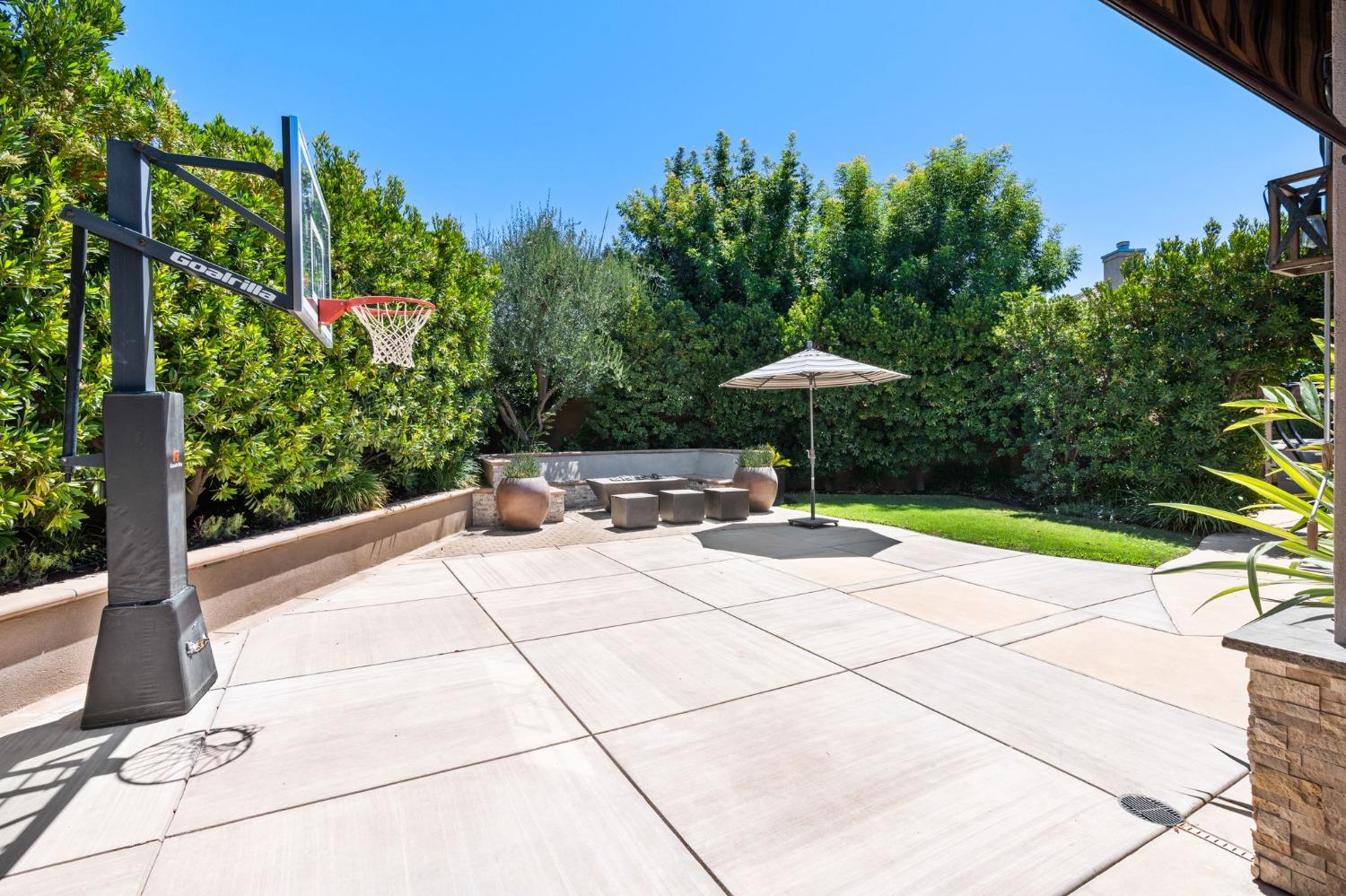 415 Heritage Avenue Clovis, CA 93619 - Photo 47 of 56 a table and chairs under an umbrella