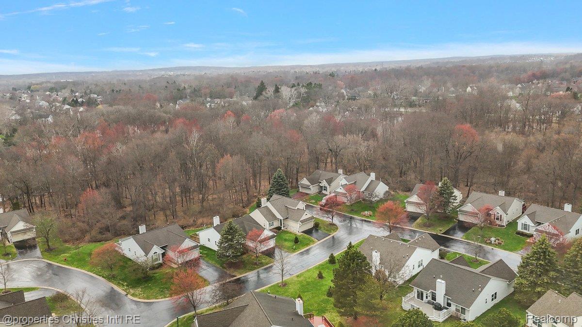 955 Rikki Ann Court Wixom, MI 48393 - Photo 13 of 54 Aerial view of residential area with a forest