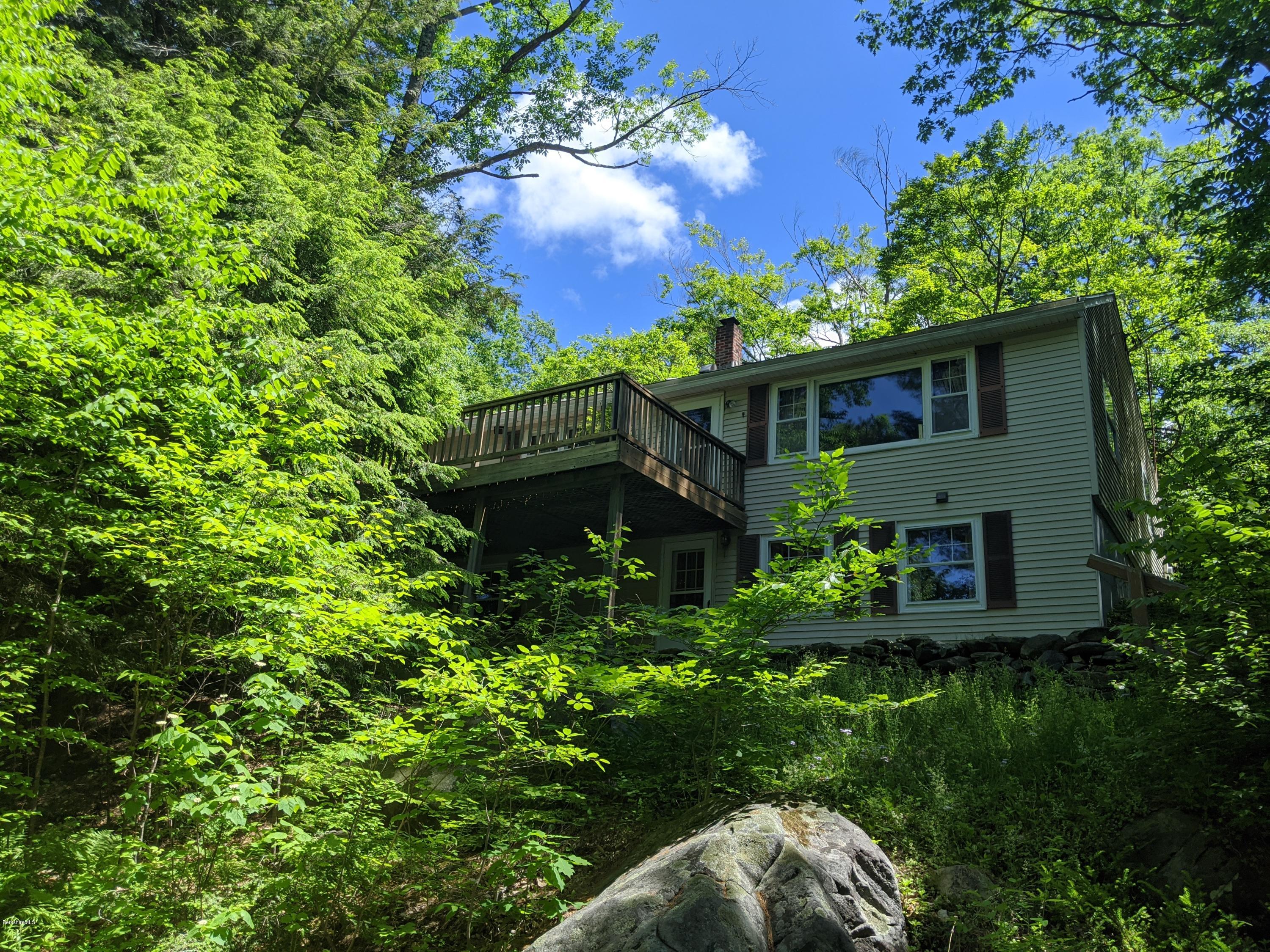 3626 Jacobs Ladder Road Becket, MA 01223 - Photo 1 of 56 a view of a house with a flower garden