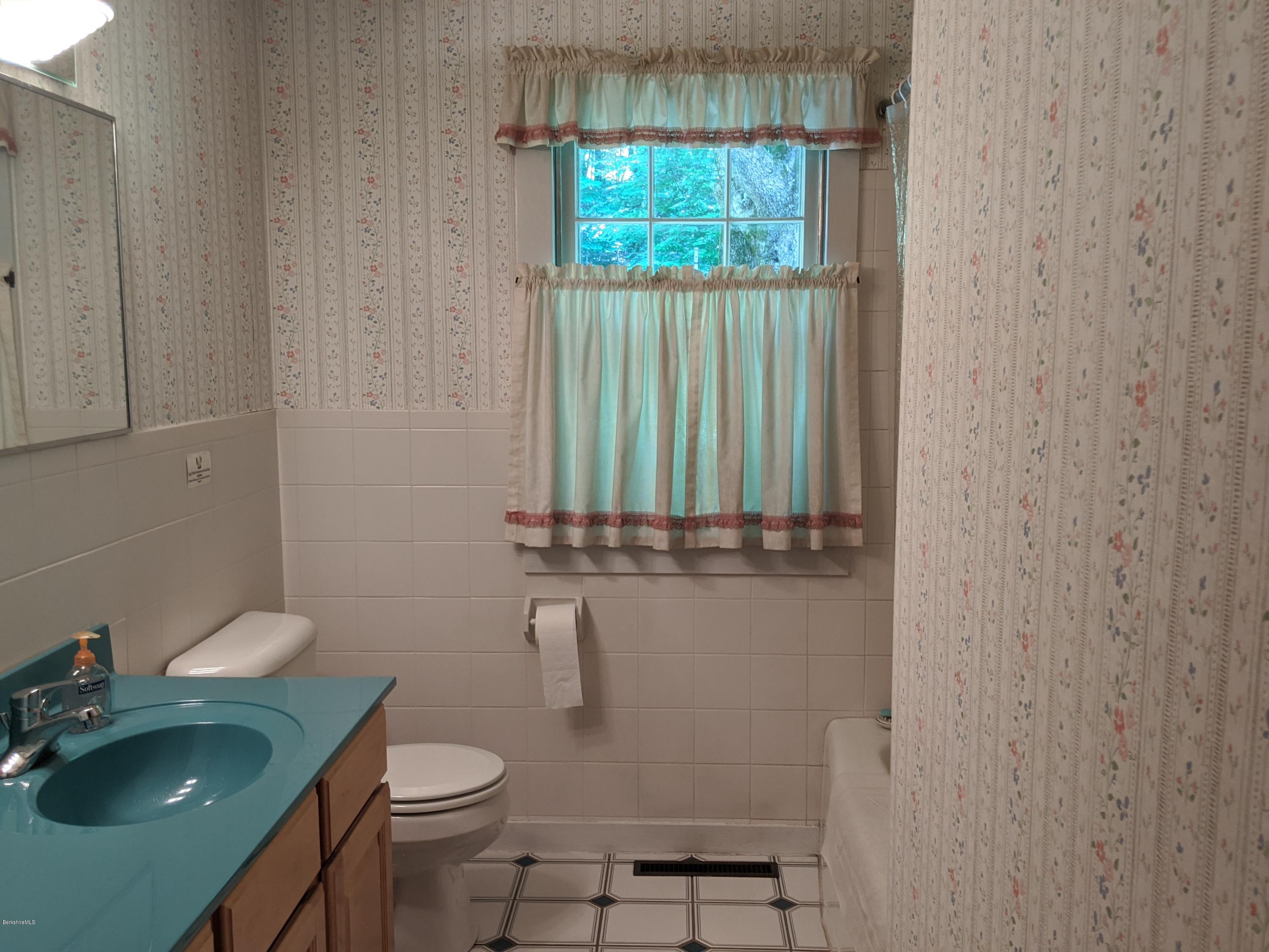 3626 Jacobs Ladder Road Becket, MA 01223 - Photo 22 of 56 a bathroom with a granite countertop toilet and a sink