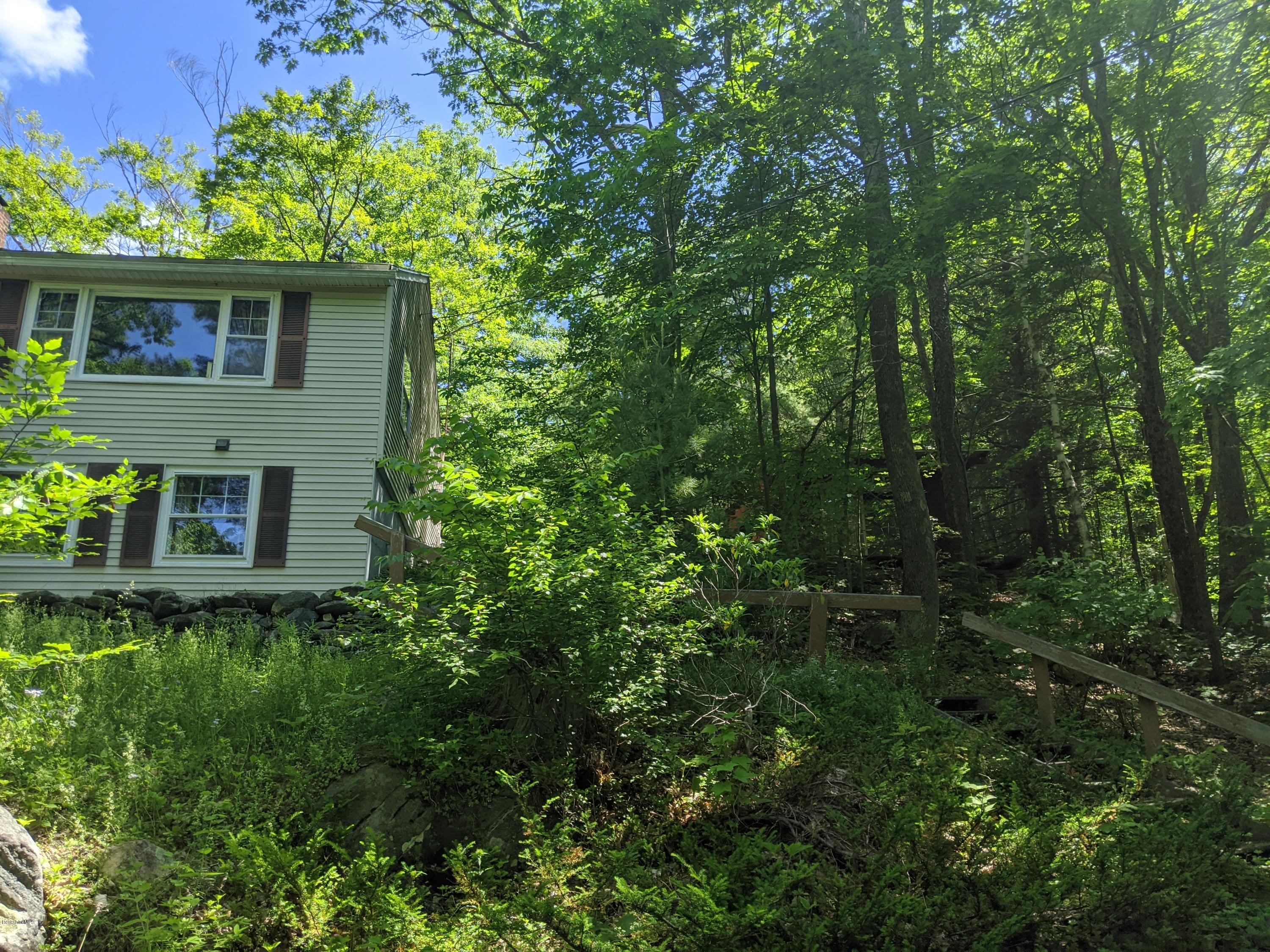 3626 Jacobs Ladder Road Becket, MA 01223 - Photo 7 of 56 a yellow house with lots of trees