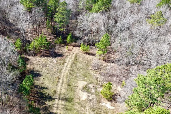 a view of a dry ground with wooden fence