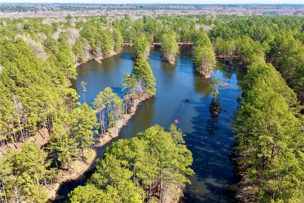 a view of a lake with lawn chairs