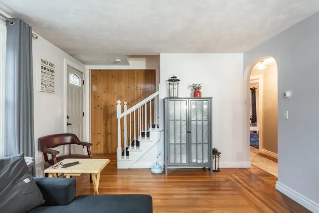 a living room with furniture and wooden floor