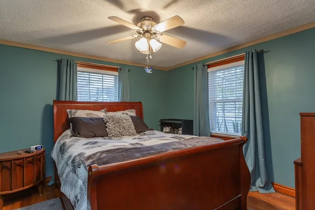 a bed sitting in a bedroom next to a window