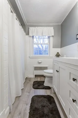 a bathroom with a sink a bathtub and a window