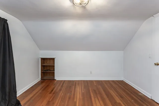 an empty room with wooden floor and closet