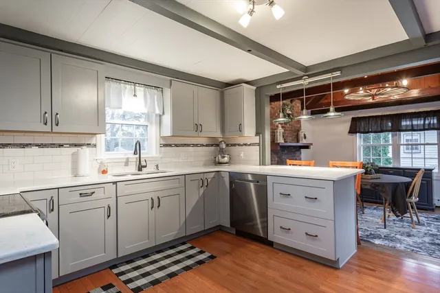 a kitchen with a sink cabinets and window