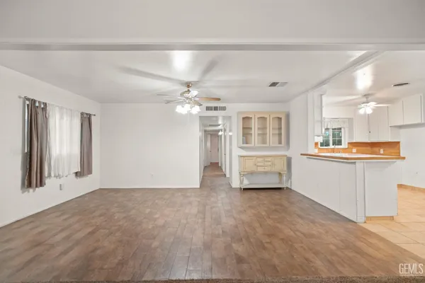 a view of an empty room with a kitchen