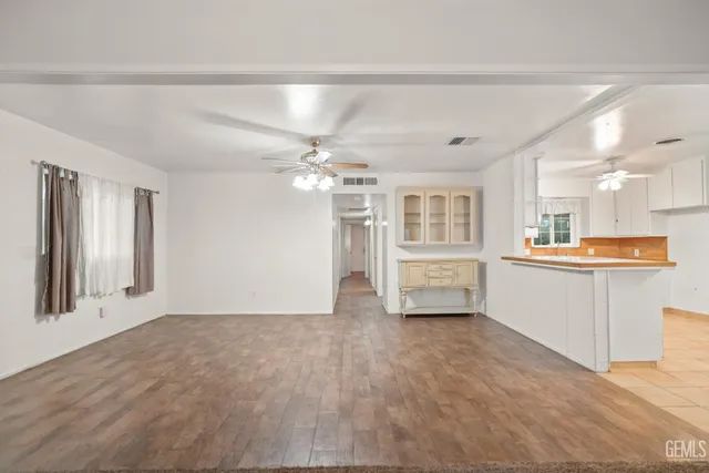 a view of an empty room with a kitchen