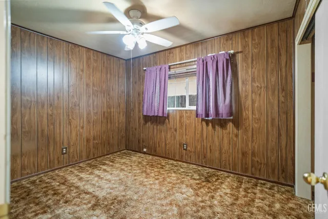 a view of a bedroom with a window and a cabinet