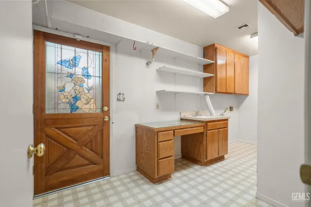 a kitchen with stainless steel appliances granite countertop a sink and a stove next to a window