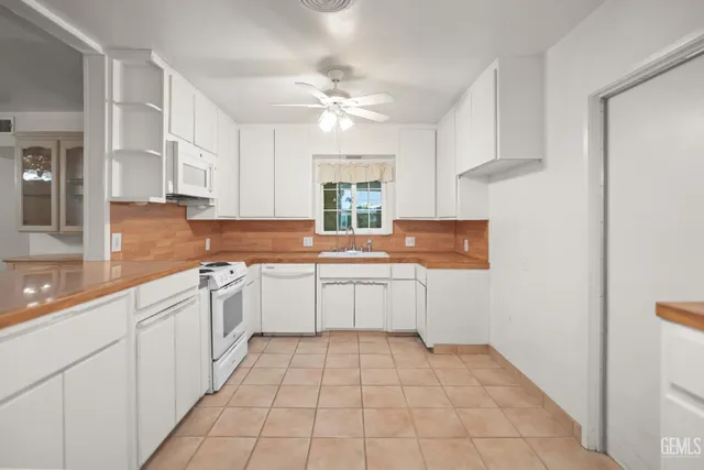 a kitchen with a sink window and cabinets