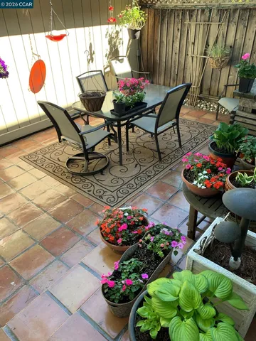 a outdoor dining space with furniture and flowers