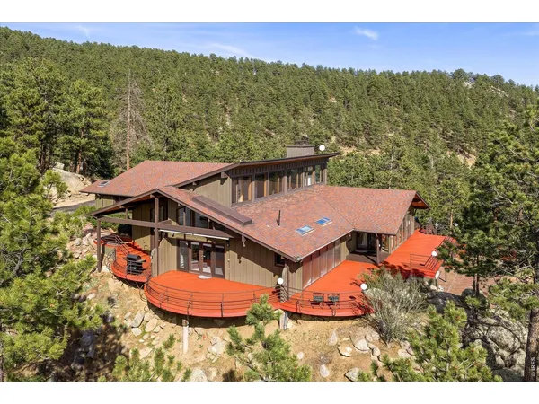an aerial view of a house with mountain view
