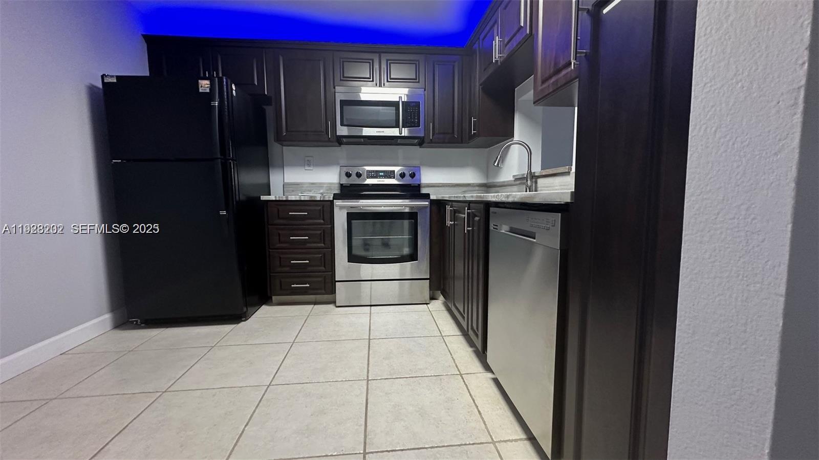 6301 North University Drive, Unit 219 Tamarac, FL 33321 - Photo 1 of 3 a kitchen with stainless steel appliances granite countertop a refrigerator and a stove top oven