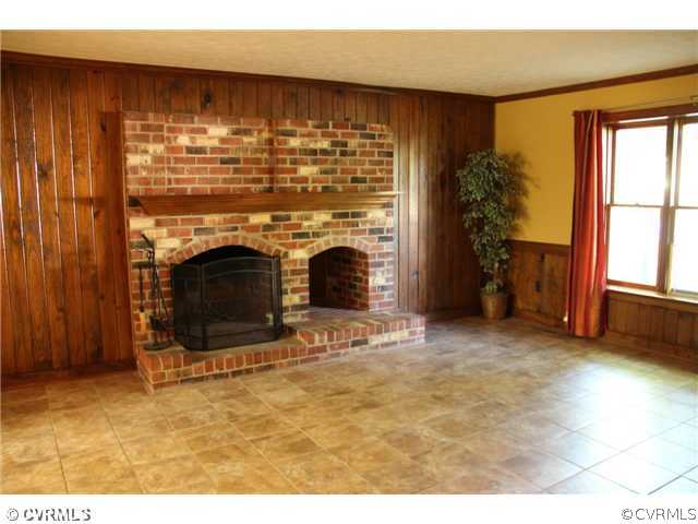 2406 Tanglebrook Road Midlothian, VA 23112 - Photo 5 of 24 a view of empty room with fireplace and window