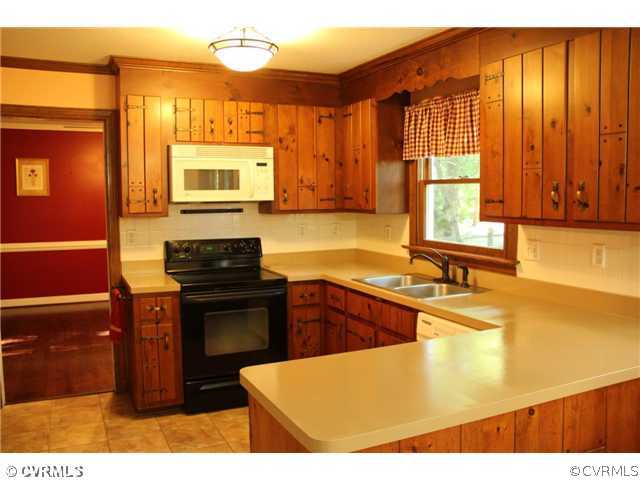 2406 Tanglebrook Road Midlothian, VA 23112 - Photo 8 of 24 a kitchen with stainless steel appliances granite countertop a sink and a microwave