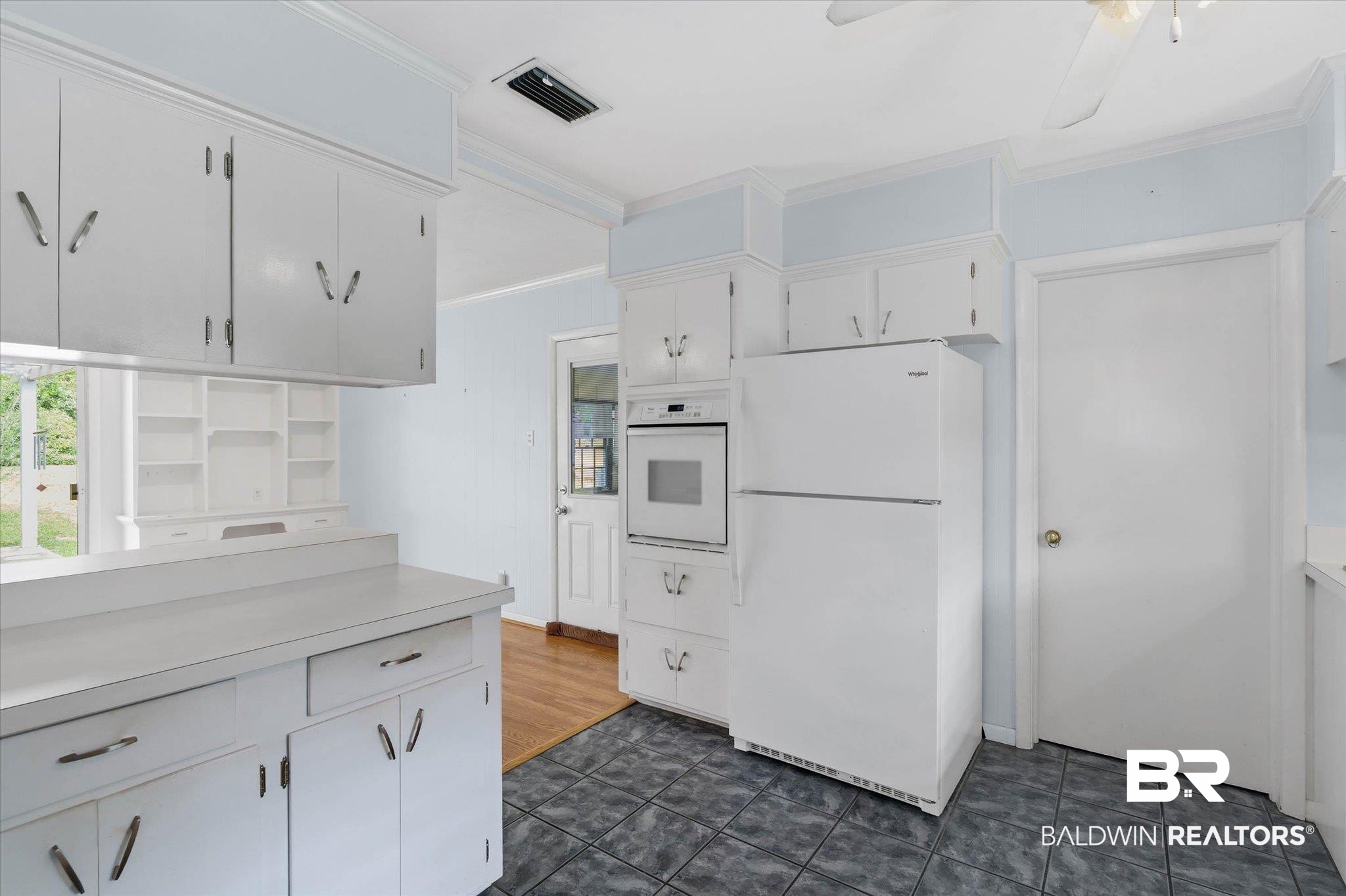 1182 Ginger Drive Mobile, AL 36693 - Photo 12 of 37 Kitchen featuring white cabinetry with ample storage, a built-in oven, and a white refrigerator