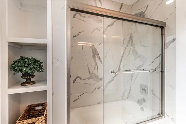 a bathroom with a glass shower door