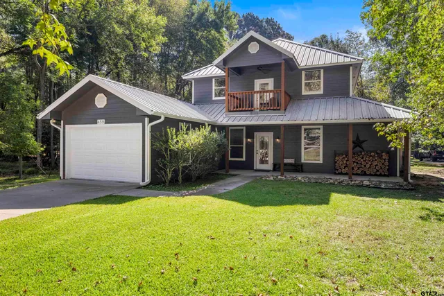 a front view of a house with a yard and porch