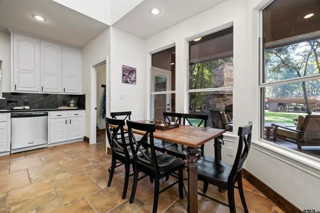 a dining room with furniture and window