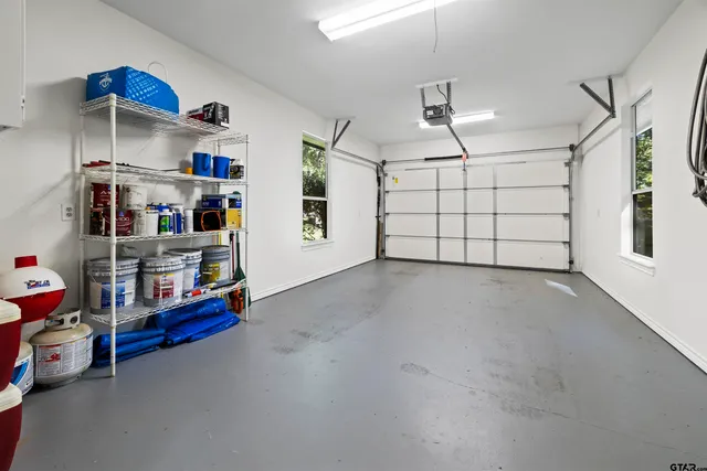 a bedroom with a bed and painting on the wall