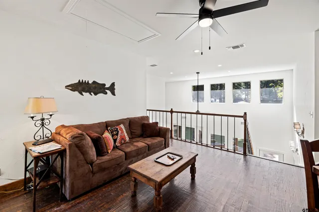 a bathroom with a granite countertop sink mirror and a toilet