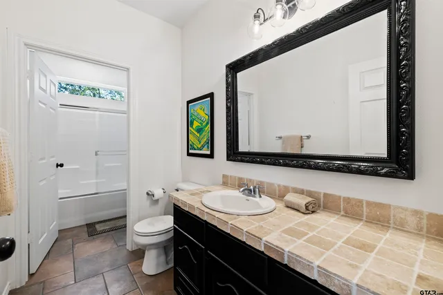a bathroom with a shower and a bath tub