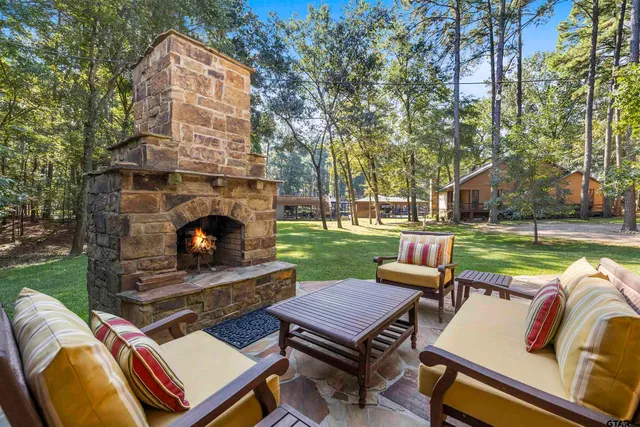 a view of a patio with chairs and floor to ceiling window