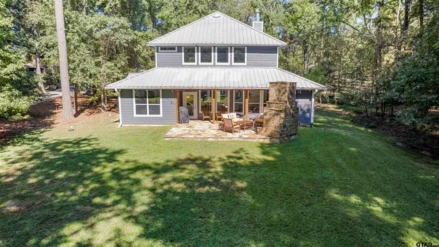 a view of a house with swimming pool and sitting area