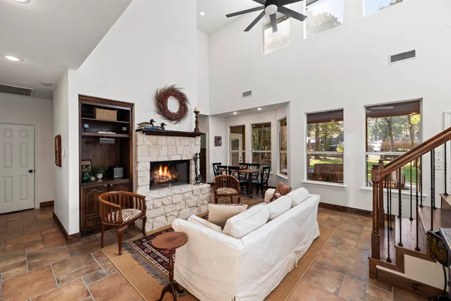 a living room with furniture a window and a fireplace