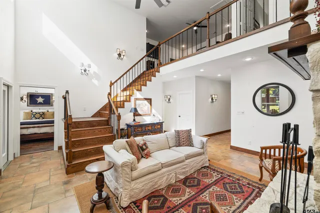 a living room with furniture and a stairs