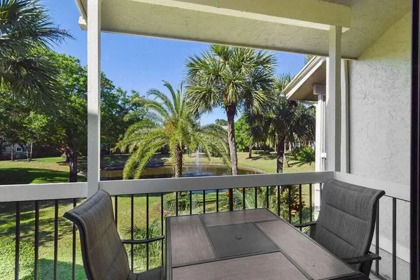 a view of a chairs and table in patio