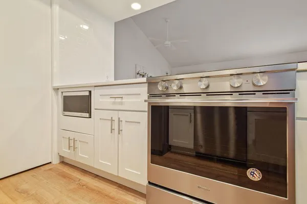 a stove top oven sitting inside of a kitchen
