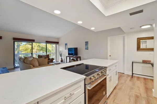 a kitchen that has a sink a stove and a table in it