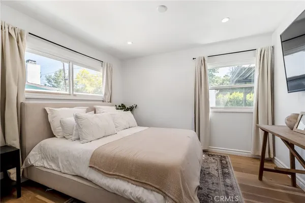 a bedroom with a bed and a large window