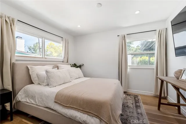 a bedroom with a bed and a large window